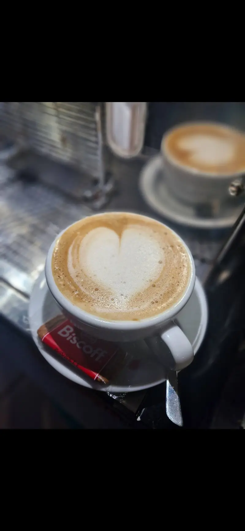 Latte art heart in coffee cup